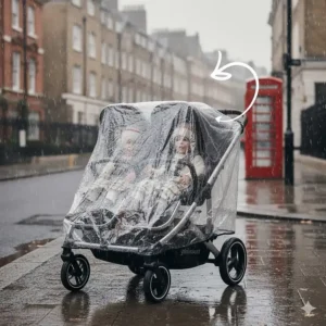 Alt text for image 6 Two young children staying dry inside a double pushchair fitted with a high-quality, clear waterproof rain cover during a rainy day in a British city.