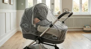 Alt text for image 4: A carrycot with a fitted apron and raincover attached, demonstrating wind and rain protection for a sleeping infant during a UK winter.