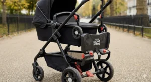 A buggy board folded up and clipped out of the way when not in use on a compact stroller.