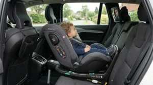 A Group 0+1 car seat rotating toward the open car door to make loading a child easier for parents.