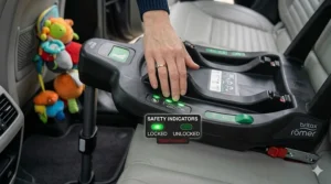 Detailed view of green safety indicators on an ISOFIX base confirming the unit is locked and the tension check is complete.