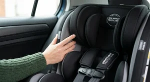 Close-up detail of the breathable fabric and side-impact protection padding on a high-value UK car seat.