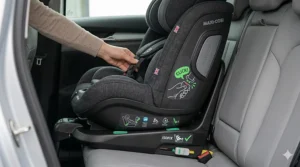 A parent adjusting the easy-to-use headrest and harness height on a Maxi-Cosi multi-stage car seat as the child grows.