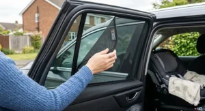 Demonstration of UV protection provided by a car window sunshade for baby during a sunny day trip.