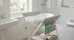 A dual-purpose baby bath and changing table under £50 positioned in a modern family bathroom.