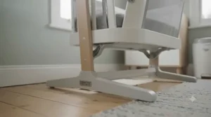 A lightweight swing crib showing its portability between rooms.