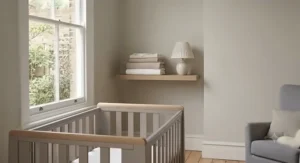 A traditional nursery furniture set styled with soft linens and neutral decor for a calming British nursery aesthetic.