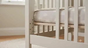 Adjustable mattress base height on wooden cot bed.