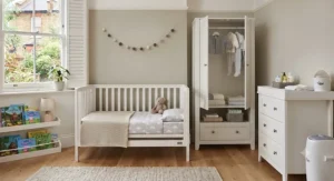 Neutral colour nursery furniture set in a styled room.