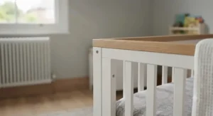 A detailed, photorealistic close-up of the wooden frame and slat construction of a nursery cot bed.