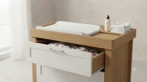 A wooden nursery dresser with a removable changing top and spacious storage drawers.