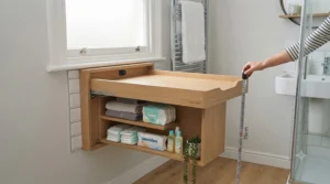 Proper installation height for a fold-down wall-mounted baby changing unit in a small cloakroom or en-suite bathroom.