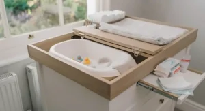 Close-up of secure raised safety barriers on a certified baby changing table.