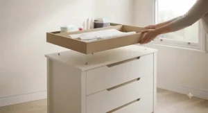 Removable changing top converting a changing table dresser combo into a standard nursery chest of drawers.