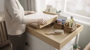 Parent comfortably changing a baby at an ergonomically designed changing dresser height, featured in top rated changing dresser reviews.