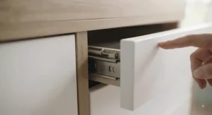 Side profile of a changing dresser with deep drawers at an optimal ergonomic height to reduce back strain during nappy changes.