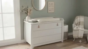 Minimalist white changing dresser paired with neutral-toned bedding and accessories.