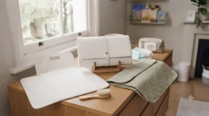 A portable nappy changing clutch with built-in storage pockets opened flat for use.
