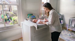 Secure baby changing station featuring raised edges and wall-anchored safety fixings for peace of mind.