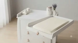 Close-up of the versatile removable changing top on a white wooden dresser.