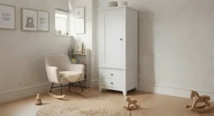 Compact white wardrobe featuring built-in drawers, positioned neatly in a small spare-room nursery to maximize floor space.