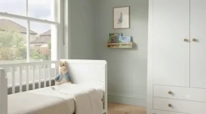 Tall white nursery wardrobe paired alongside a coordinating baby change table in a modern flat.