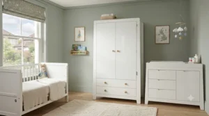 White nursery wardrobe part of a matching three-piece furniture set including a cotbed and dresser.